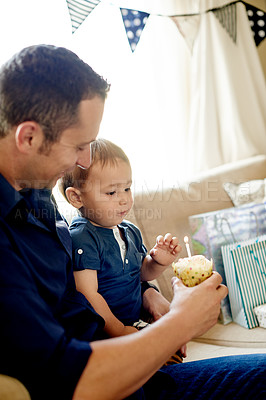 Buy stock photo Birthday, celebration or cupcake with father and son in living room of home together for party. Candle, dessert or wish with boy child and single parent man in apartment for development or growth
