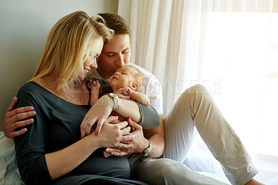 Buy stock photo Bedroom, happy and parents with child in home for loving relationship, bonding and affection. Family, morning and embrace of mom, dad and newborn baby for security, trust and parenting together