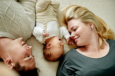 Buy stock photo Relax, love and parents with baby on bed for bonding, care and family time in home together. Happy, rest and newborn with mother and father in bedroom for support, safety and childcare in house.