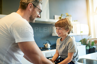 Buy stock photo Bonding, conversation and father with son in kitchen of home together for morning routine. Love, security or smile with boy child and single parent man speaking in apartment for development or growth