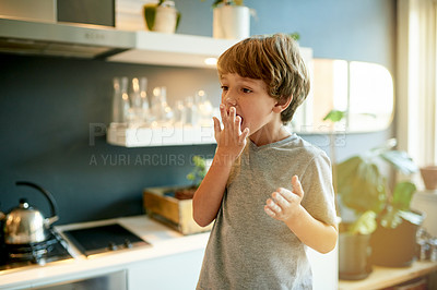 Buy stock photo Eating, hands and flour with kid in kitchen for cooking breakfast, food and growth. Child development, hunger and nutrition with boy baking in home for feeding, wellness and meal prep for pancakes