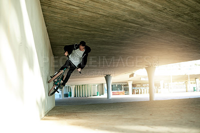 Buy stock photo Man, bicycle and jump stunt in city with challenge, talent or action outdoor for extreme sports. Skill, trick or practice with person, athlete or ride for performance, bike and energy in urban park