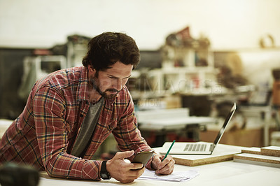 Buy stock photo Man, research and phone in woodwork workshop for trade, stock and supply chain. Craftsmanship, notebook or artisan with mobile in warehouse for progress update, project checklist or small business