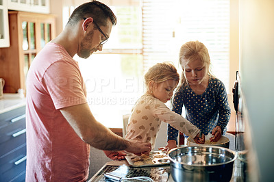 Buy stock photo Baking, home and father with girls, learning and bonding together with ingredients. Family, parent and dad in kitchen, daughters or help with recipe, cooking and development with utensils or dessert