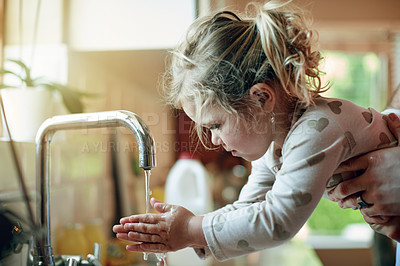 Buy stock photo Health, hand washing and kid in home with support, bacteria prevention or teaching wellness in development. Safety, parent and child in kitchen with faucet, germ protection or care in hygiene routine