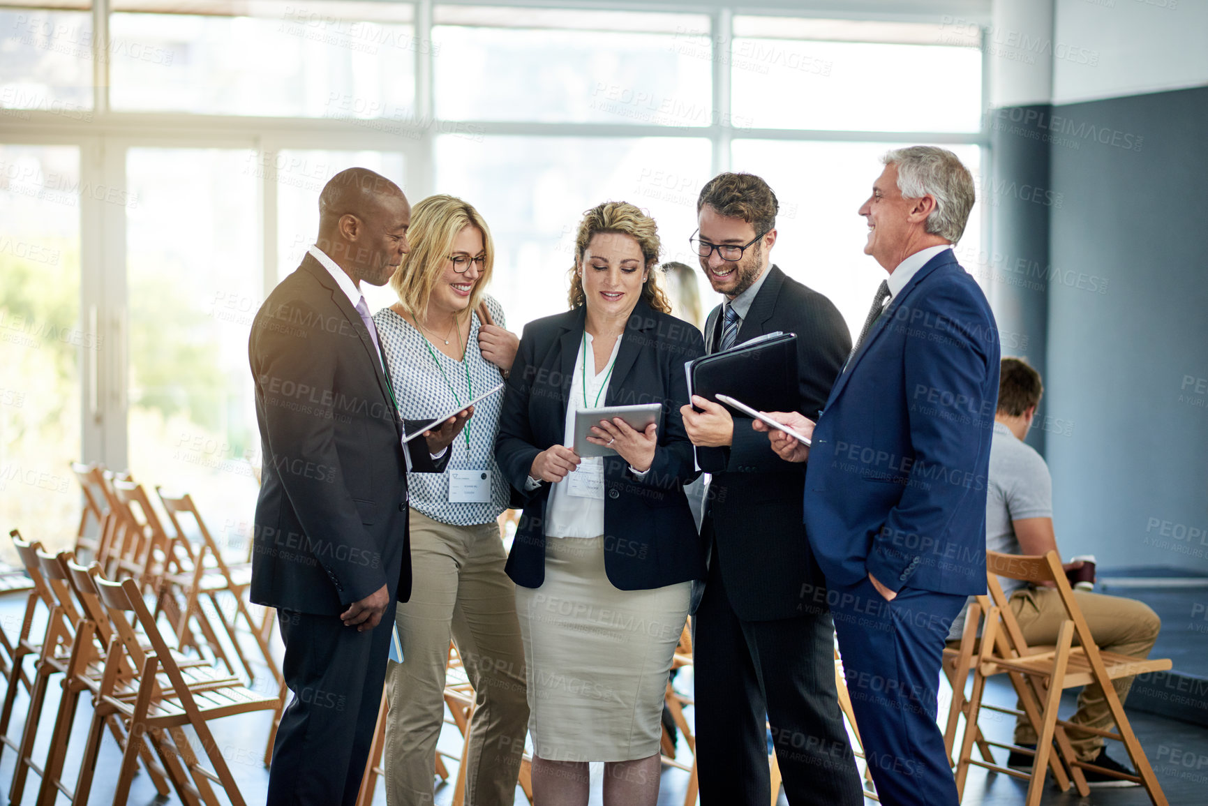 Buy stock photo Business people, meeting and laughing with tablet in convention for funny joke or comedy. Happy group, team or employees with smile or technology for social tradeshow or humor together in workplace