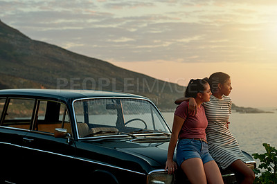 Buy stock photo Shot of two young women enjoying a road trip