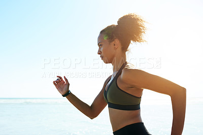Buy stock photo Ocean, athlete and woman running for fitness with exercise, training and endurance routine. Space, female person and sprinting with blue sky, sports workout and marathon practice of wellness on beach