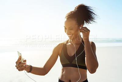Buy stock photo Fitness, phone and woman with earphones at beach for exercise, music or workout podcast. Smile, runner and athlete with tech for marathon training, flare and streaming audio or getting ready by ocean