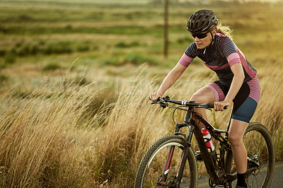 Buy stock photo Fitness, road and woman cycling with bicycle for training, race and triathlon or competition. Sports athlete, workout and cyclist with bike for cardio, exercise and outdoor trail and nature space