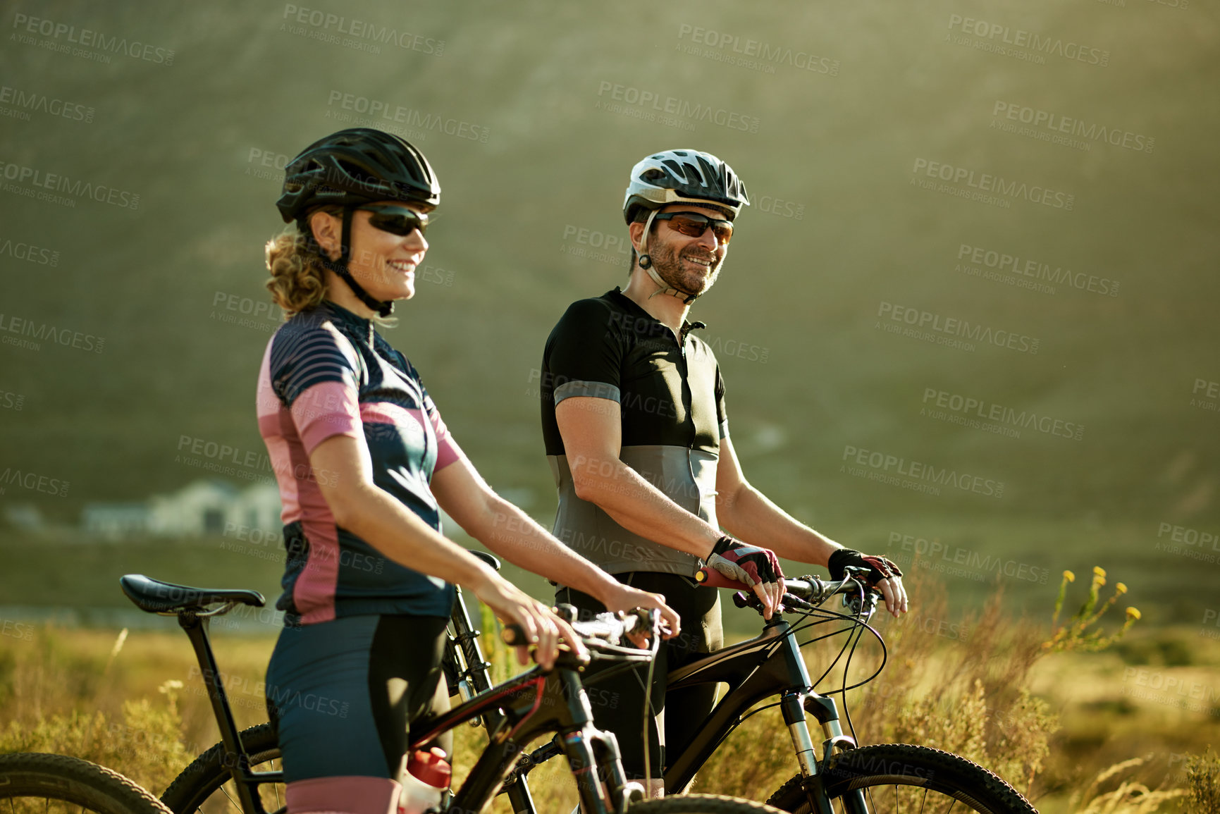Buy stock photo Cycling, smile and fitness with couple in nature for workout break, relax and bonding together. Wellness, triathlon training and resting stop with man and woman with bicycle outdoor for bike team