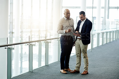 Buy stock photo Office, tablet and business men in discussion for online proposal, project and financial review. Corporate lobby, meeting and people on digital tech for planning, collaboration and finance report