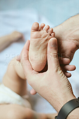 Buy stock photo Small, care and parent showing baby feet, newborn human and love for parenthood. Family, cute and hand of a father holding a foot of a child for loving, tenderness and youth in the bedroom of a house