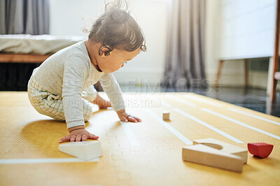Buy stock photo Boy kid, blocks and playing on floor in home, childhood growth and fun development. Baby, educational wooden toys and games for montessori learning, creative puzzle and motor skills in nursery room