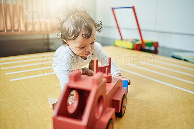 Buy stock photo Baby, boy and wooden car toys on floor in nursery, childhood growth or creative development. Kids truck, playing and games for education, montessori learning or cognitive coordination of motor skills