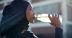 Muslim, drinking and black woman with water in city for outdoor fitness, workout break or hydration. Active, female person or profile with mineral liquid, bottle or beverage for recovery or rest