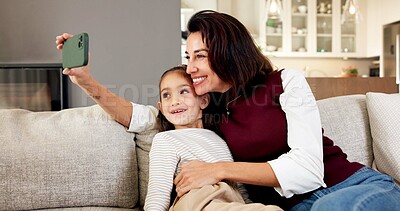 Buy stock photo Happy, mom and kid in home with selfie, profile picture and social media post for childhood memories. Woman, girl child and smile in living room with photography, family or relax together on weekend.
