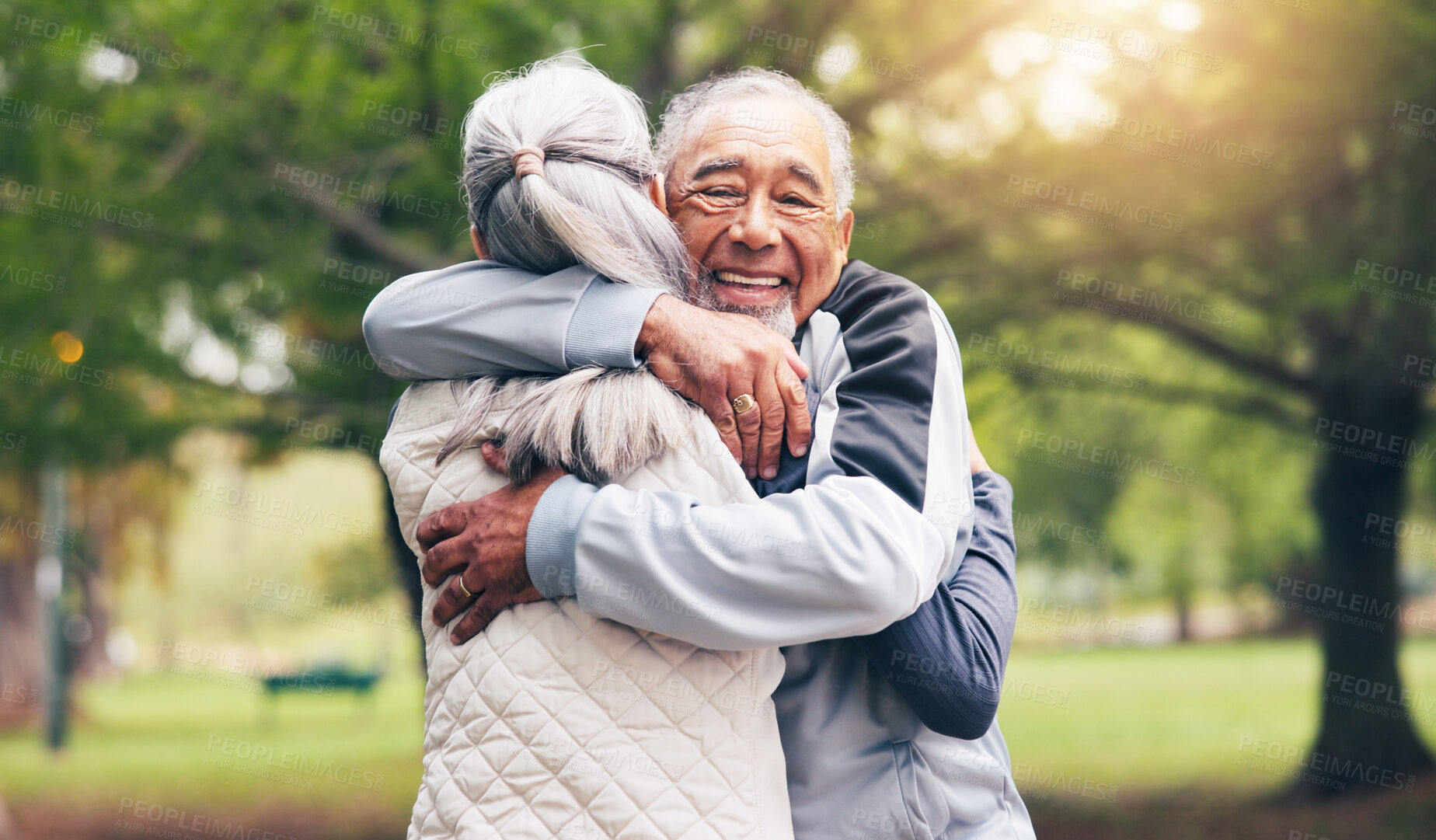 Buy stock photo Senior, fitness and happy couple with hug in park for outdoor workout, greeting or introduction. Active, elderly man and woman with smile or embrace for support, motivation or comfort in nature