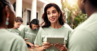 Buy stock photo Woman, talk and team with tablet for volunteering, sign up and appoint task of community outreach. Smile, coordinator and people with digital for charity, participation and job allocation for welfare