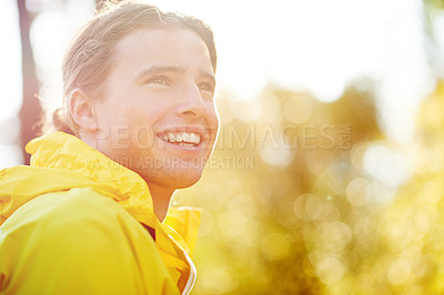 Buy stock photo Outdoor, raincoat and man with smile for hiking, trail adventure and thinking on break by bokeh. Nature, male person and hiker with happiness for fitness, trekking and wellness with positive thoughts