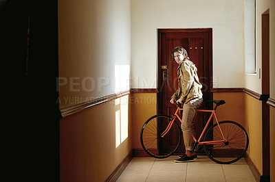 Buy stock photo Bicycle, travel and man in apartment hallway for eco friendly, transportation or college commute. College dorm, male student and bike for university, carbon footprint and academy for morning cycling