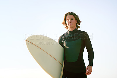 Buy stock photo Thinking, blue sky and man with surfboard at beach for water sports, adventure and surfing. Surfer, nature and person by ocean, sea and outdoor for holiday, vacation and hobby on weekend in Portugal