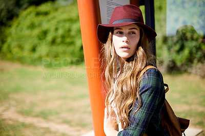 Buy stock photo Thinking, girl and waiting at bus stop in city for travel, public transport and sightseeing abroad. Female teenager, relax and exploring for taxi delay, morning commute and getaway trip for holiday
