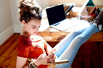 Buy stock photo Break, education and phone with girl student in study of home for app, learning or social media. Communication, development and text message with person in apartment for college or university