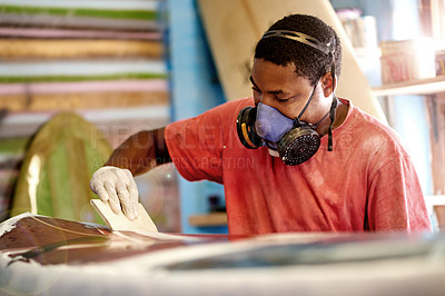 Buy stock photo Manufacturing, man and sanding surfboard in workshop for production process, design or shape. Surf, factory and African person with tools to polish deck or creative craftsmanship with respirator