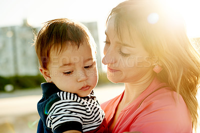 Buy stock photo Happy, love and mother with baby outdoor for bonding together on summer vacation or weekend trip. Smile, lens flare and mom holding boy toddler with growth, family and development on holiday.