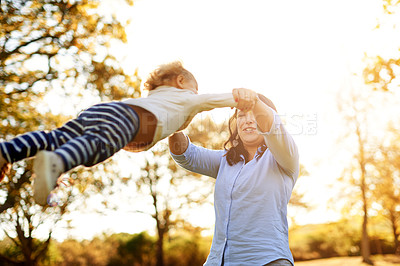 Buy stock photo Mother, spin child and fun at park with smile, bonding and flare with love, play and summer in nature. People, mom and daughter with games for toddler, swing or holding hands with care in Argentina