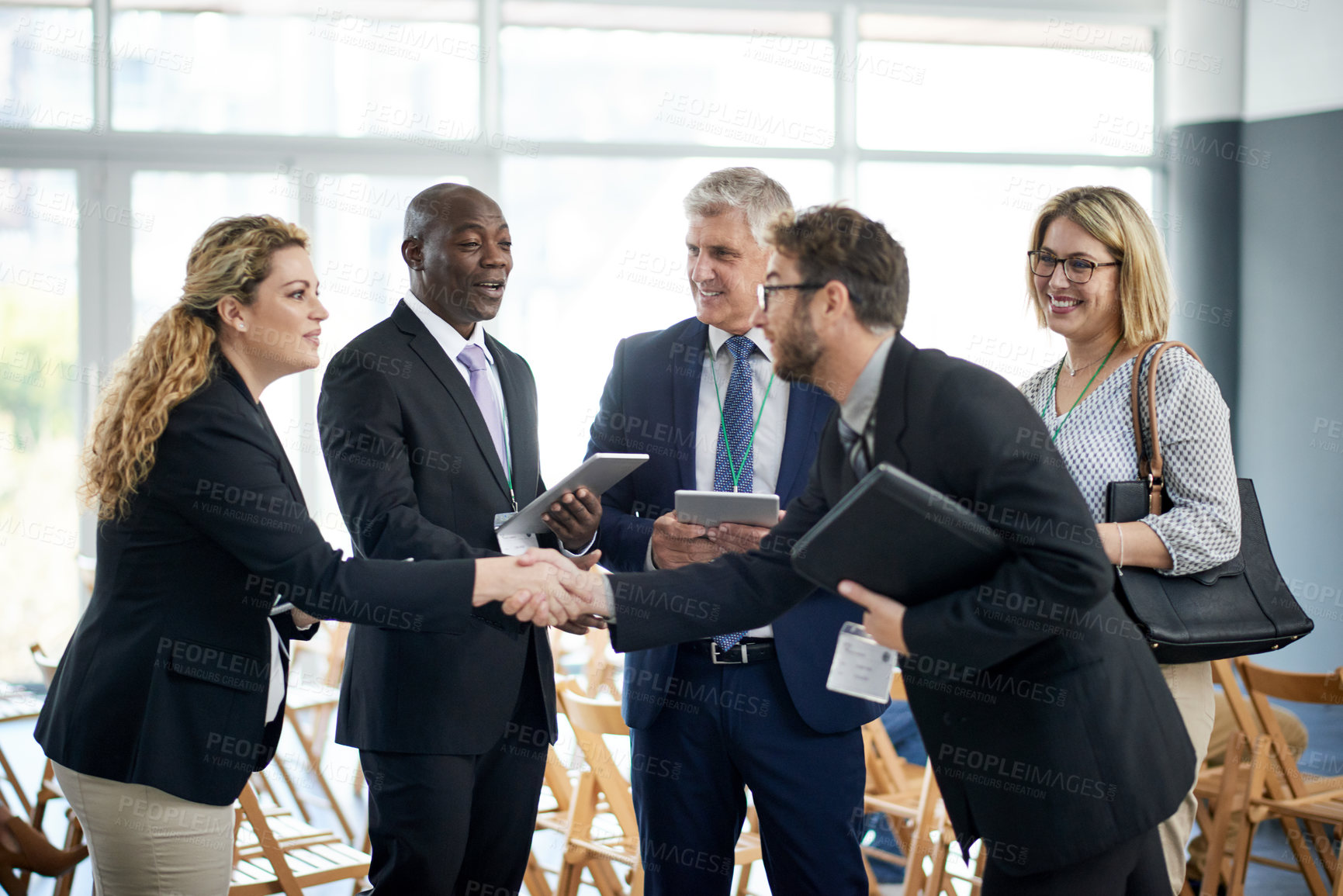 Buy stock photo Businessman, tablet and shaking hands for networking at conference with app, introduction and woman at meeting. People, exchange contact and tech for hello, smile or group at international convention