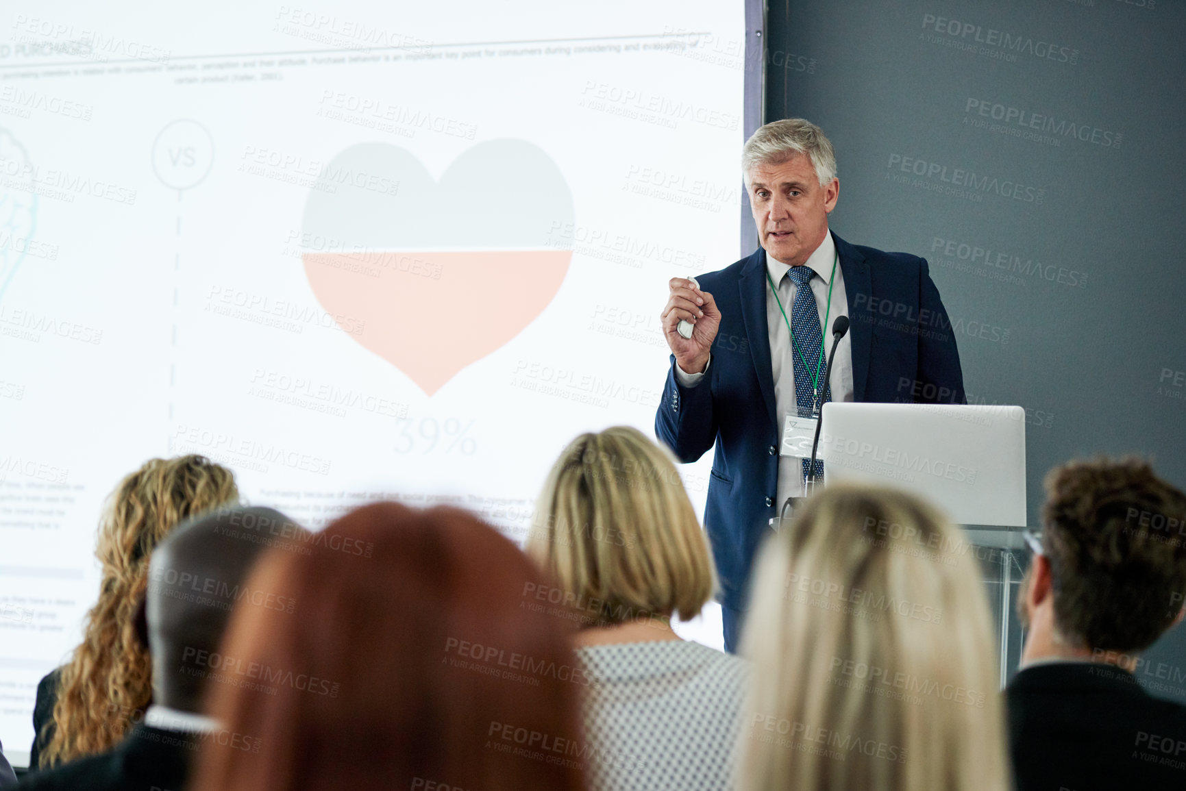 Buy stock photo Presentation, business or mature man in office at podium, communication or audience in training workshop. Presenter, vision or CEO in workplace with laptop, coaching or feedback in workforce learning