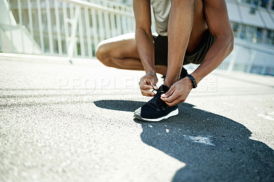 Buy stock photo Person, hands and tying with shoes for fitness, workout preparation or exercise on asphalt in city. Active, runner and getting ready with tie or sneakers for balance, safety or health and wellness