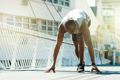 Buy stock photo Athlete, black man and begin race in city for fitness, start exercise and competition. Male person, ready and preparation for running challenge, sports workout and marathon practice for wellness
