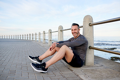 Buy stock photo Fitness, man and rest in portrait on floor with workout fatigue, exhausted or tired of marathon. Blue sky, runner or relax at promenade with exercise burnout, endurance or recovery break from cardio
