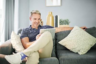 Buy stock photo Tablet, happy and relax with man on sofa for streaming service, connection and watching movie. Film subscription, entertainment and series browsing with person in living room of home for break