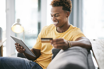 Buy stock photo Black man, tablet and credit card on sofa with smile for deal, ecommerce and budget on web in home. Person, happy and fintech app on couch for discount sale, online shopping and easy payment at house