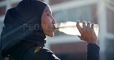 Buy stock photo Muslim, drinking and black woman with water in city for outdoor fitness, workout break or hydration. Active, female person or profile with mineral liquid, bottle or beverage for recovery or rest