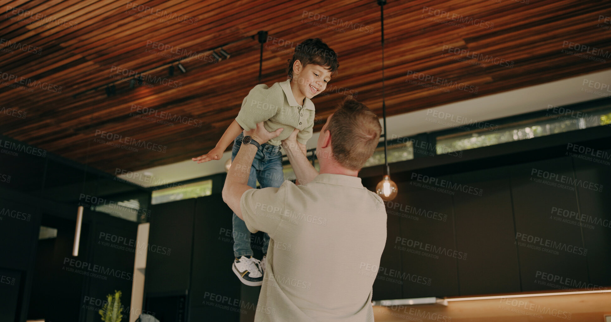 Buy stock photo Father, love and lift child in home with support, quality time and bonding together with smile. Happy boy, dad and play flying game in family house with care, trust or security with parent connection