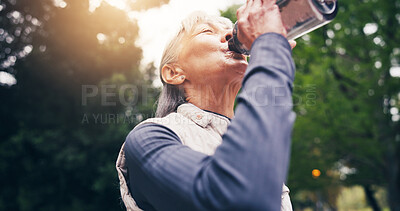 Buy stock photo Senior, woman and drinking water in nature for hydration, outdoor fitness or workout break in park. Active, elderly or female person with mineral liquid bottle for thirst, sustainability or recovery