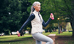 Outdoor, fitness and senior woman with dumbbells, endurance or workout routine for health in nature. Park, wellness and retired person with equipment for exercise, training and physical activity