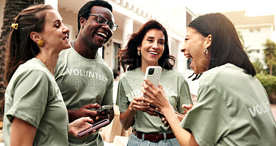 Buy stock photo Volunteer, group and laughing outdoor with phone, funny charity video or bonding on team break. NGO, happy people and show mobile for community service meme, social interaction and shared experience