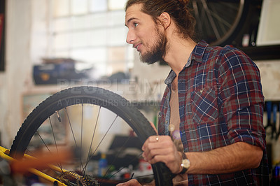 Buy stock photo Happy, entrepreneur and man with bicycle, shop or repairing wheel with smile, inspection or service. Fixing, tire and person with idea for maintenance, restoration or technician with bike in workshop