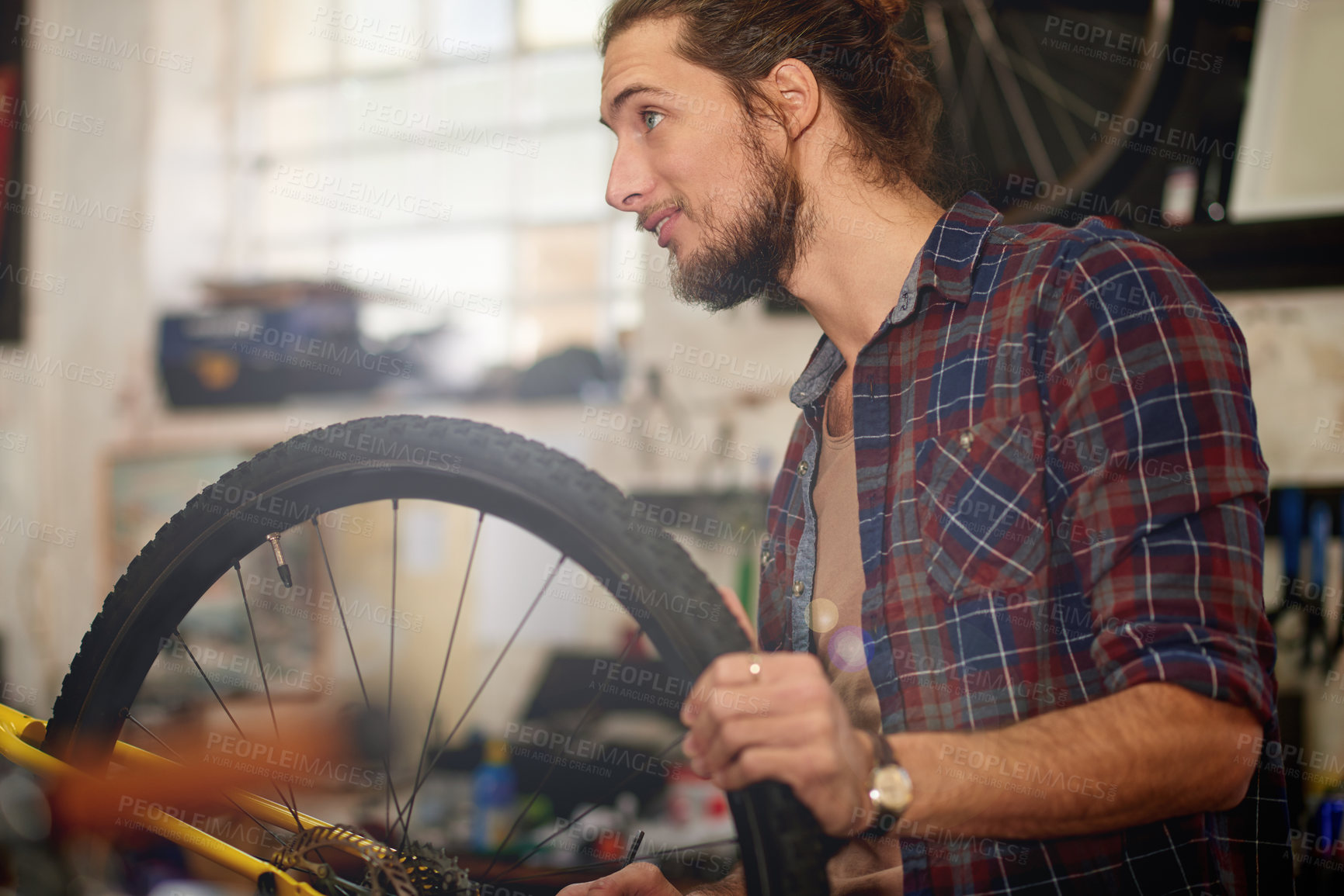 Buy stock photo Happy, entrepreneur and man with bicycle, shop or repairing wheel with smile, inspection or service. Fixing, tire and person with idea for maintenance, restoration or technician with bike in workshop