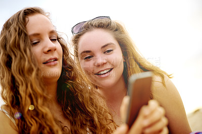 Buy stock photo Phone, friends and girls at beach for holiday, travel and vacation for bonding together. Teenager, social media and people relax with smile, technology and ocean trip in Miami for summer adventure