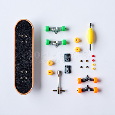 Buy stock photo Top view, mini and skateboard with tools in studio for sport, physical activity or creative hobby. Above, custom design and white background with finger size equipment for collection or color choice