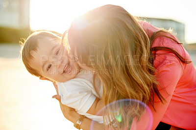 Buy stock photo Mother, baby and kiss outdoor for love, bonding and affection for family travel with sunshine. Portrait, boy and woman with single parent, vacation adventure and happy moment flare with hug in nature