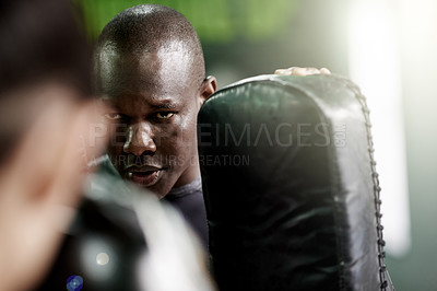 Buy stock photo Man, boxer or personal trainer with gloves for block, self defense or martial arts training in gym. Male person, coach or boxing mentor with pads for fitness, fighting or exercise in health club