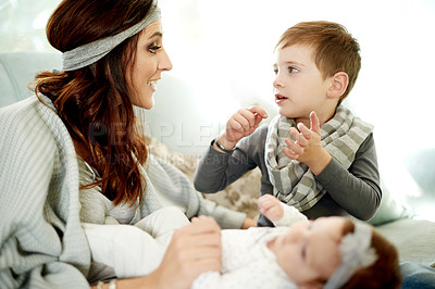 Buy stock photo Mother, children and talking in home with baby for storytelling or learning with parent. Mom, kids and conversation with boy in living room for support, communication and love with family together